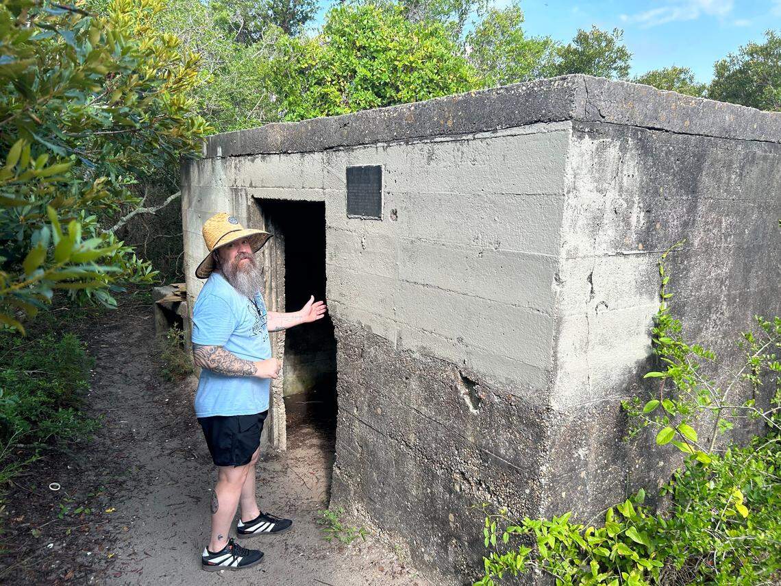 Rob Hill enters the World War II bunker where Robert Harrill, the Fort Fisher Hermit, lived for 17 years. Tourists at Fort Fisher still stop to look.