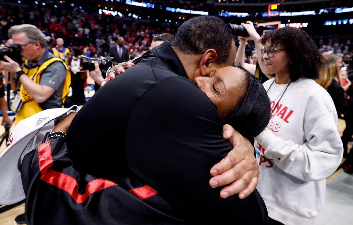 N.C. State head coach Kevin Keatts hugs his wife Georgette after the Wolfpack’s 76-64 victory over Duke in NCAA Tournament Elite Eight game at the American Airlines Center in Dallas, Texas, Sunday, March 31, 2024.