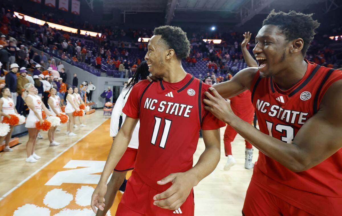 N.C. State's Musa Sagnia (13) and Quadir Copeland (11) celebrate after N.C. State’s 80-76 overtime victory over Clemson at Littlejohn Coliseum in Clemson, S.C., Tuesday, Jan. 20, 2026.