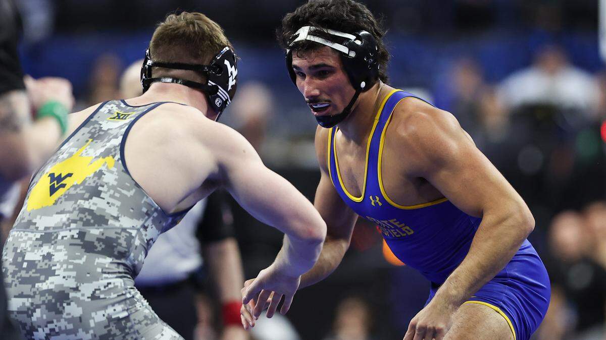 Mar 20, 2025; Philadelphia, PA, USA; AJ Ferrari of California State University wrestles Ian Bush of West Virginia during day one of the NCAA Wrestling championships at Wells Fargo Center.