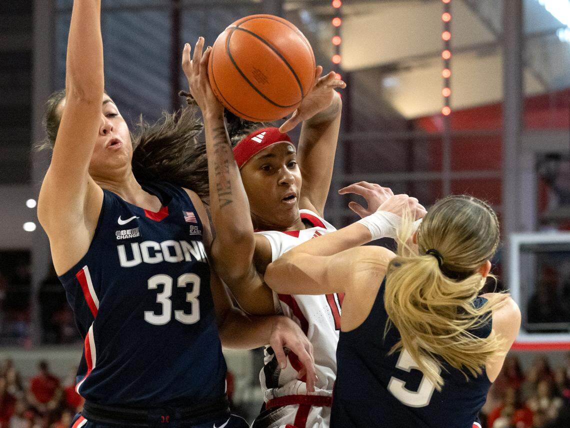 UConn’s Paige Bueckers (5) draws an offensive foul against N.C. State’s Aziaha James during the first half of the Wolfpack’s game on Sunday, Nov. 12, 2023, at Reynolds Coliseum in Raleigh, N.C.