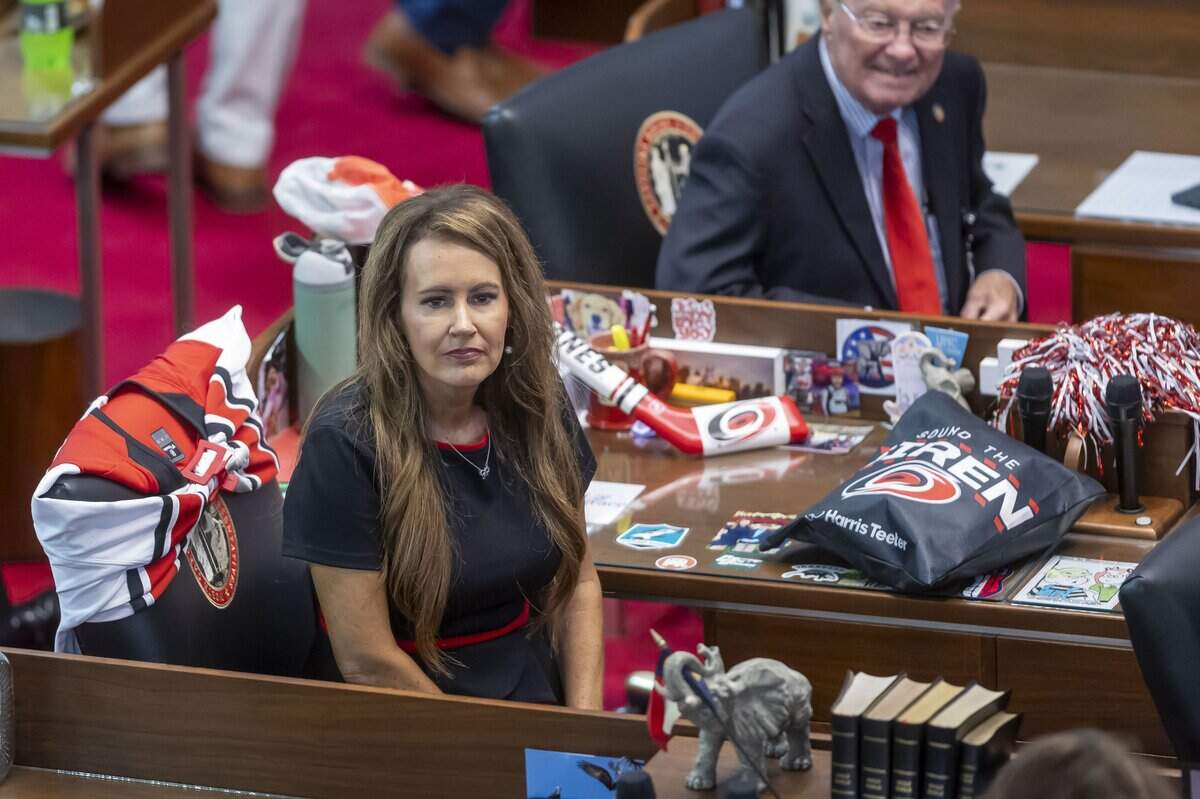 Rep. Tricia Cotham of Mecklenburg County, surrounded by Carolina Hurricanes memorabilia, awaits the arrival of the Stanley Cup, in the House chamber on Tuesday, June 23, 2026 at the General Assembly in Raleigh, NC.
