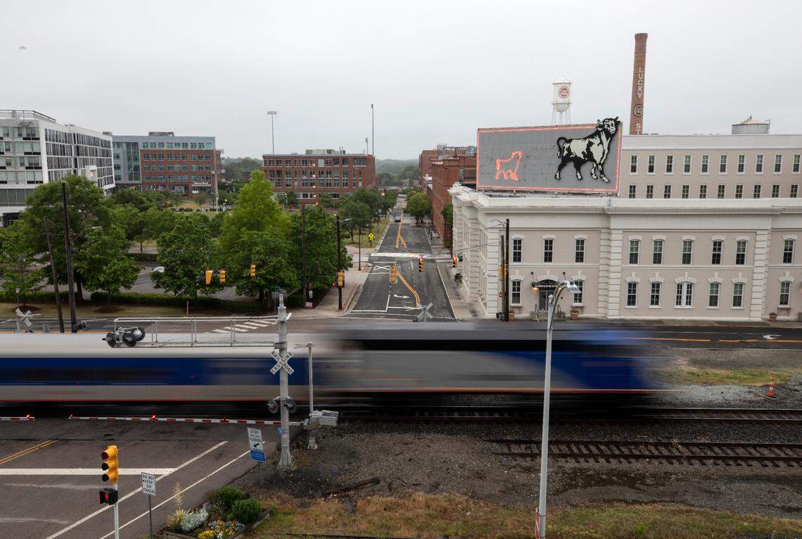 A Piedmont train travels past the American Tobacco District in downtown Durham.