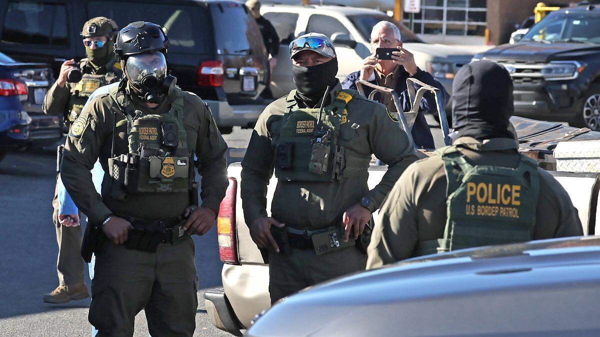 U.S. Customs and Border Patrol agents wait in the parking lot of the Compare Foods on North Tryon St. in Charlotte, NC on Monday, November 17, 2025.