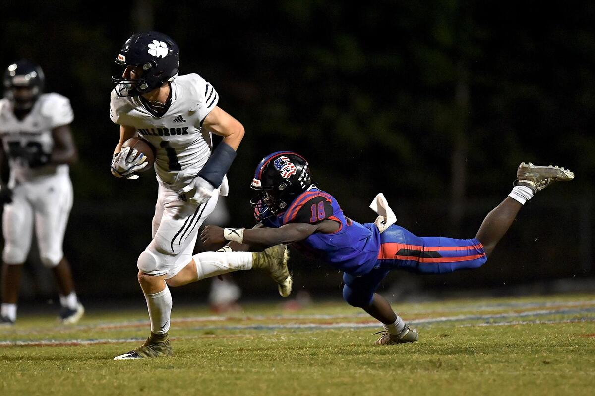 Millbrook’s Ty Broughton (1) runs for the touchdown against Sanderson’s Michel Kladegue (18) during the second half. The Sanderson Spartans and the Millbrook Wildcats met in a football game in Raleigh, N.C. on September 16, 2022.