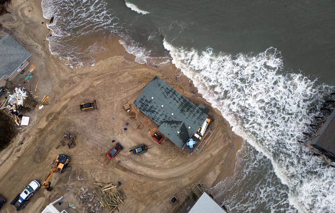 House movers slowly relocate the Buxton beach house of Lat and Debby Williams.  The couple bought the house from Debby’s parents, who had owned it since 1981. When they retired in 2017, the Williamses settled there full-time — then three rows back from the ocean. Now, with severe erosion threatening the property, their single-story house is being relocated in two stages: first to safety away from the surf, then to a new lot five blocks inland.The first stage of the move took 12 hours. The house, loaded onto a truck after being lifted from its original location.