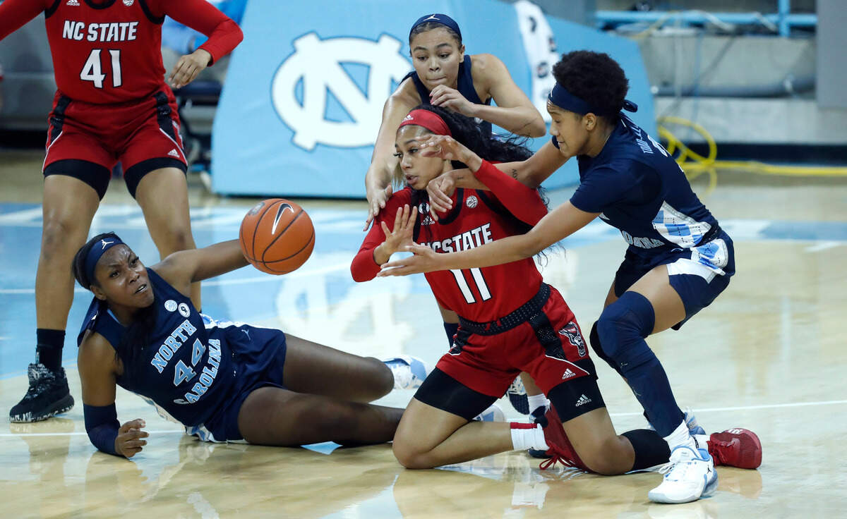 North Carolina’s Janelle Bailey (44), Stephanie Watts (5) and Kennedy Todd-Williams (3) and N.C. State’s Jakia Brown-Turner (11) go after the ball during the second half of UNC’s 76-69 victory over N.C. State at Carmichael Arena in Chapel Hill, N.C., Sunday, February 7, 2021.