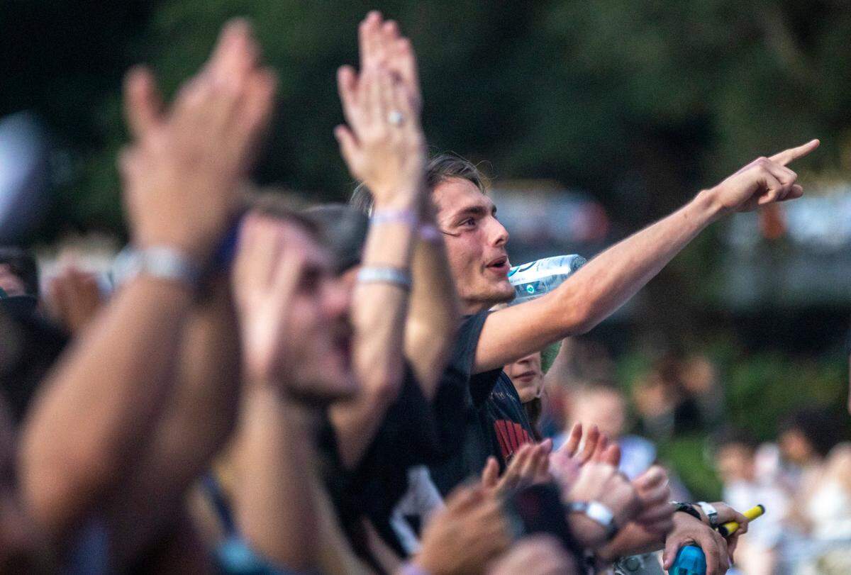 Concert-goers listen to Parquet Courts play Moore Square in Raleigh during the third day of the Hopscotch Music Festival Saturday, Sept. 11, 2021.