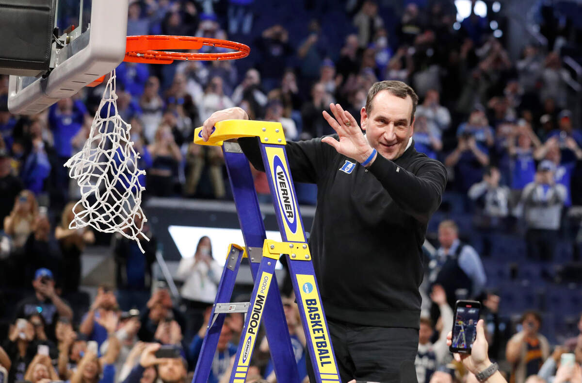 Duke head coach Mike Krzyzewski waves to the crowd as he gets ready to cut the net down after Duke’s 78-69 victory over Arkansas in the NCAA Tournament West Regional finals at the Chase Center in San Francisco, Calif., Saturday, March 26, 2022.