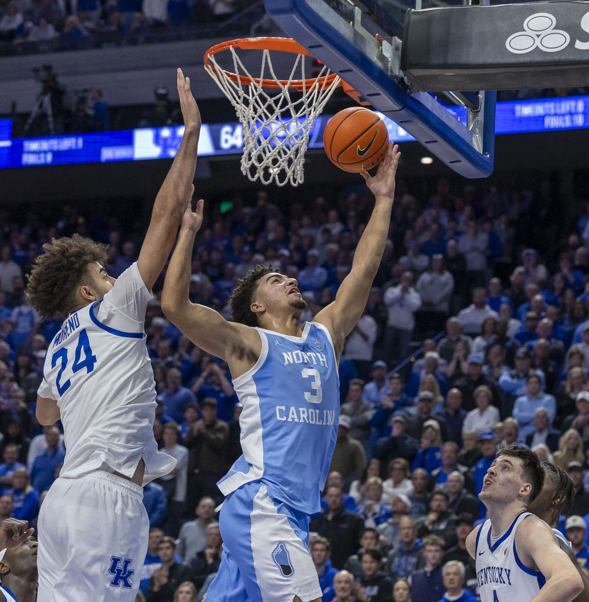 North Carolina guard Derek Dixon (3) scores the game winning basket with 16 seconds to play against Kentucky center Malachi Moreno (24) on Tuesday, December 2, 2025, at Rupp Arena in Lexington, Ky.