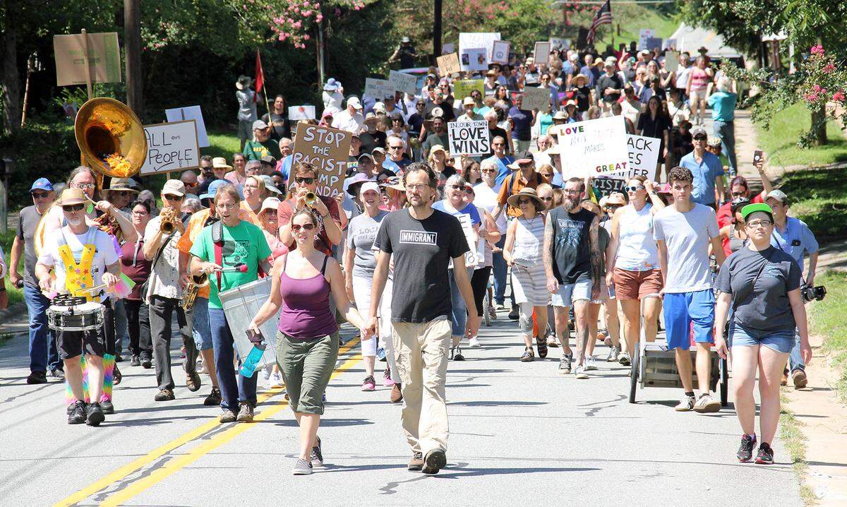 Hundreds of people march in Hillsborough, N.C., against white supremacy Aug. 31, 2019. The march followed repeated visits to downtown Hillsborough by a handful of people carrying Confederate flags and by about 20 members of the Ku Klux Klan and their supporters, several in hooded robes, on Aug. 24, 2019. The march was organized by the Hate-Free Schools Coalition and Hillsborough Progressives Taking Action. “I’m proud of you,” speaker Jason “Crazy Bear” Campos-Keck told the crowd. “I’m proud of you for showing what the human heart can do.”