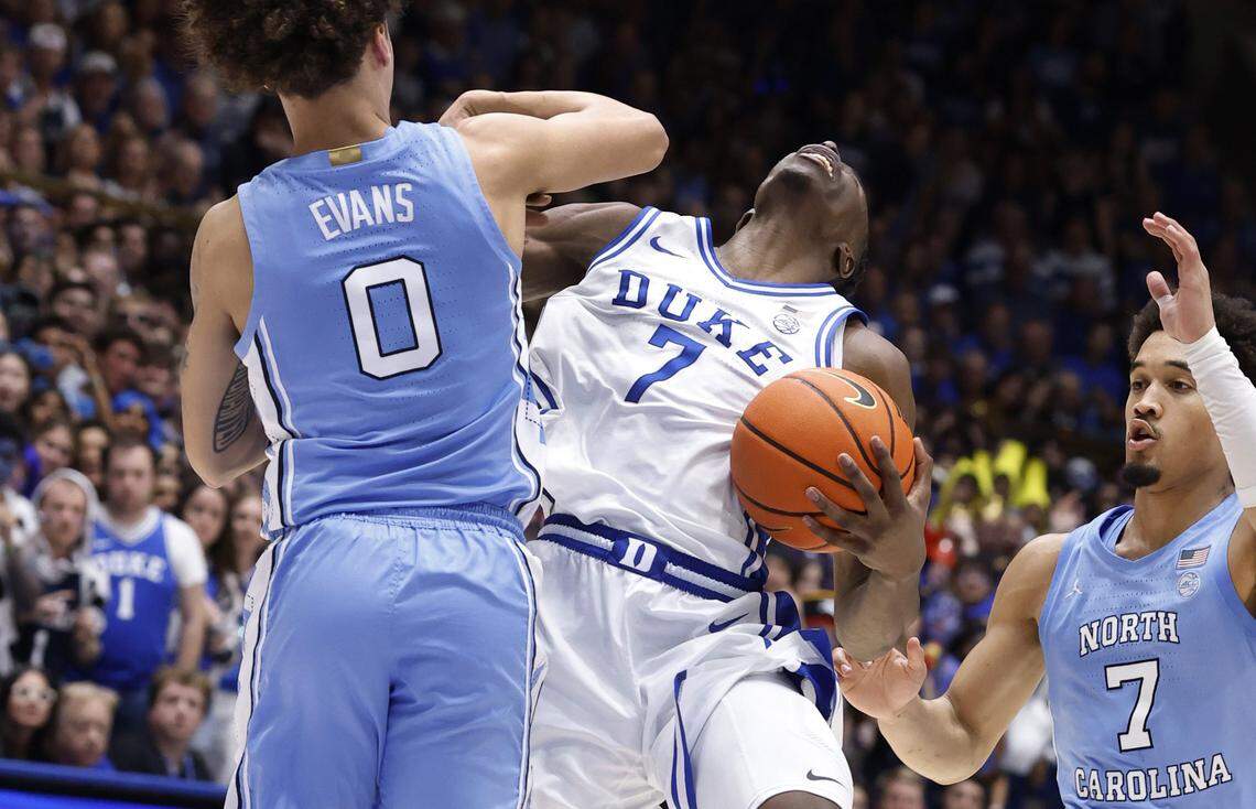 North Carolina's Kyan Evans (0) fouls Duke’s Dame Sarr (7) during the second half of Duke’s 76-61 victory over UNC at Cameron Indoor Stadium in Durham, N.C., Saturday, March 7, 2026.