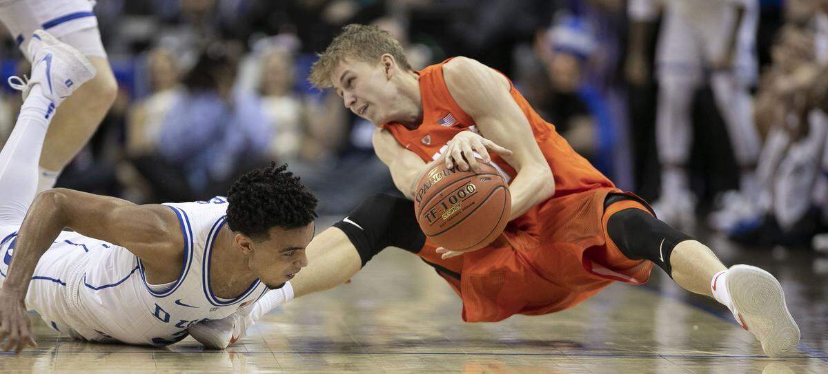Syracuse’s Marek Dolezaj (21) looses the ball under pressure from Duke’s Tre Jones (3) during the first half on Thursday, March 14, 2019 during quarter finals of the ACC Tournament at Spectrum Center in Charlotte, N.C.