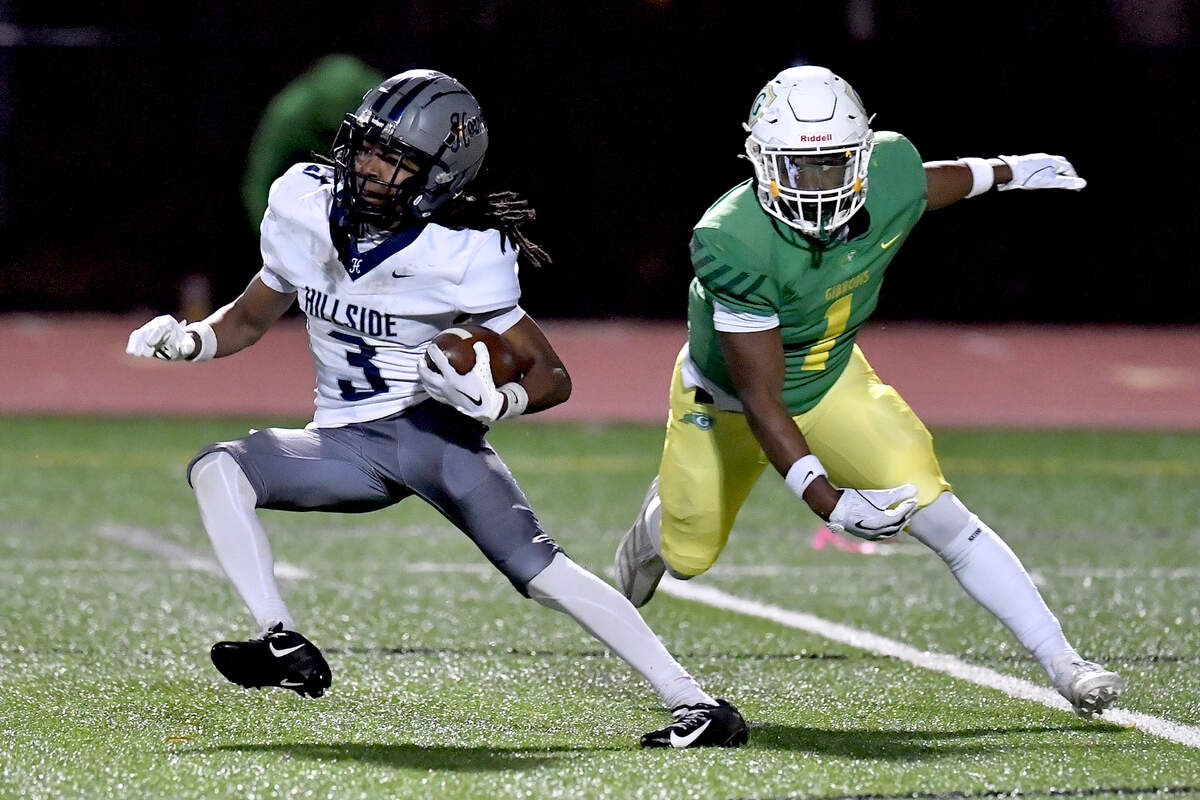 Hillside’s Erick Bonner (3) runs for yards off the kickoff ahead of Cardinal Gibbons’ Corban McDaniel (1) during the first half. The Cardinal Gibbons Crusaders and the Durham Hillside Hornets met in the third round of the NCHSAA 4A playoffs in Raleigh, N.C. on November 29, 2024.