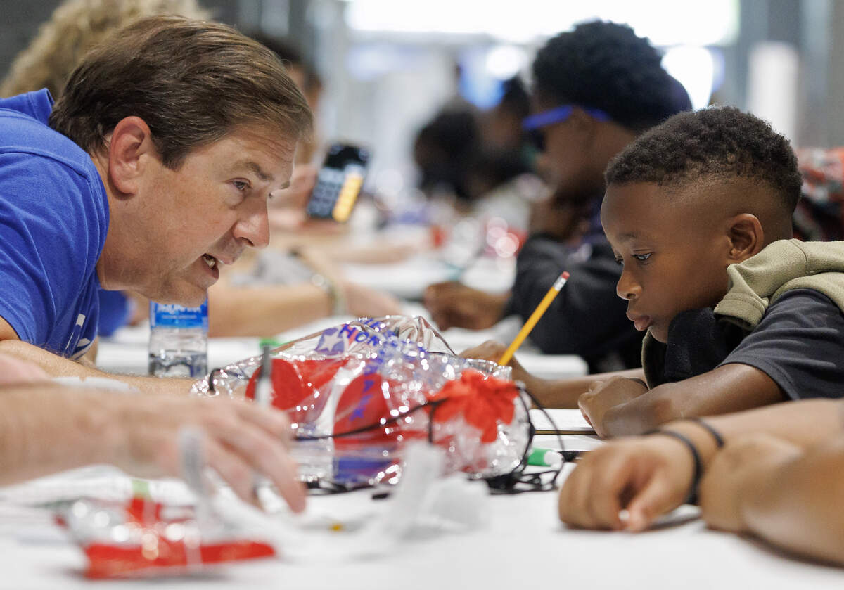 Will Rayner, a volunteer with First Horizon Bank, works one-on-one with Kel to develop a budget, setting aside a percentage of his paycheck for a nest egg and other savings.