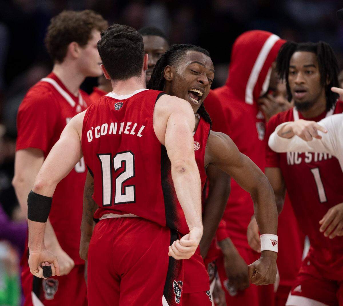 N.C. State’s D.J. Horne (0) chest bumps teammate Michael O’Connell (12) after O’Connell’s three-point shot at the buzzer forced overtime against Virginia during the semi-finals of the ACC Men’s Basketball Tournament at Capitol One Arena on Friday, March 15, 2024 in Washington, D.C. The Wolfpack defeated Virginia 73-65 in overtime.