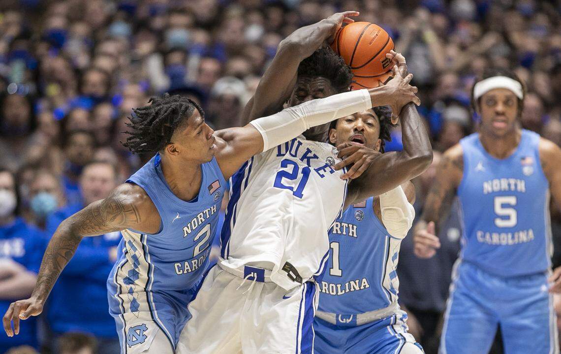 North Carolina’s Leaky Black (1) and Caleb Love (2) trap Duke’s A.J. Griffin (21) during the second half on Saturday, March 5, 2022 at Cameron Indoor Stadium in Durham, N.C.