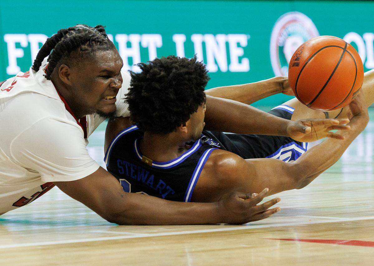 Duke’s Sean Stewart grabs a loose ball away from N.C. State’s DJ Burns Jr. during the second half of the Blue Devils’ 79-64 win on Monday, March 4, 2024, at PNC Arena in Raleigh, N.C.