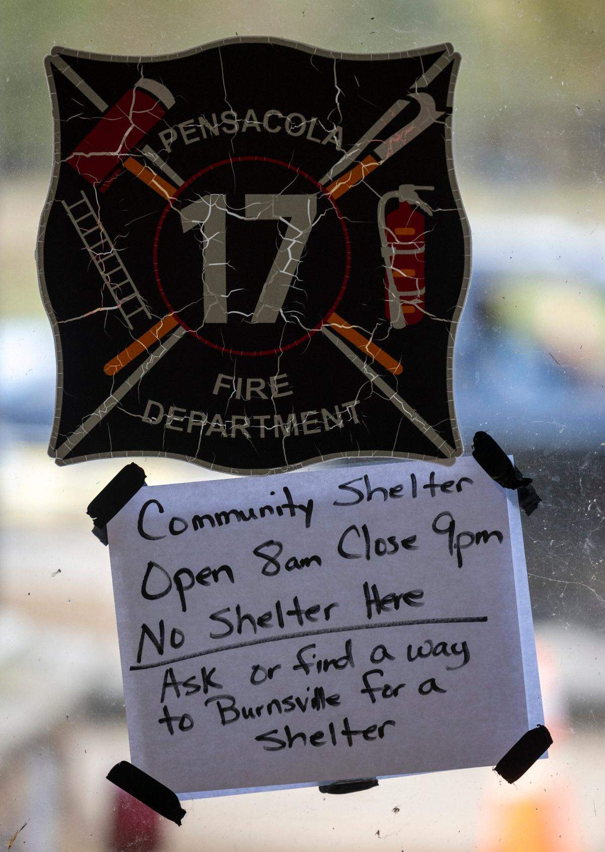 A sign in the window of the Pensacola Fire Department offers residents a place to spend the day, have some food and use Starlink to call family and friends on Thursday, October 3, 2024 in Pensacola, N.C. The area has been heavily damaged from Hurricane Helene, with the roads inaccessible due to flood damage.