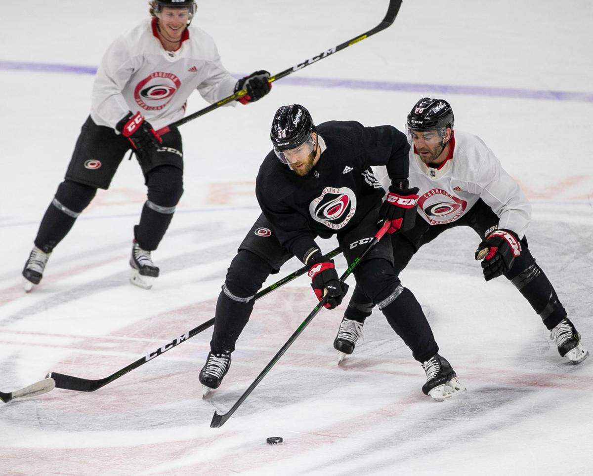Carolina Hurricanes’ Jani Hakanpaa (58) controls the puck in front of Jordan Martinhook (48) during practice on Saturday, May 15, 2021 at PNC Arena in Raleigh, N.C. The Hurricanes will host Nashville in the first round of the Stanley Cup Playoffs on Monday May 17.