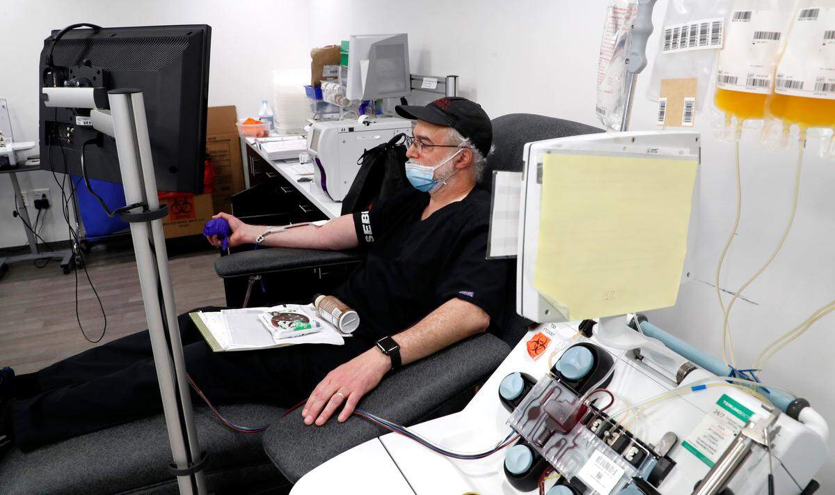 Dr. Charles Gainor donates convalescent plasma at The Blood Connection in Raleigh, N.C., Monday, May 18, 2020. The four pouches of plasma donated by Gainor, a COVID-19 survivor, will be used to help treat hospitalized patients with severe cases of coronavirus.