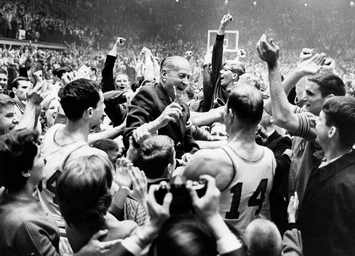 NC State’s Everett Case is lifted aloft by players and fans after the Wolfpack won the 1965 ACC Tournament in Reynolds Coliseum.