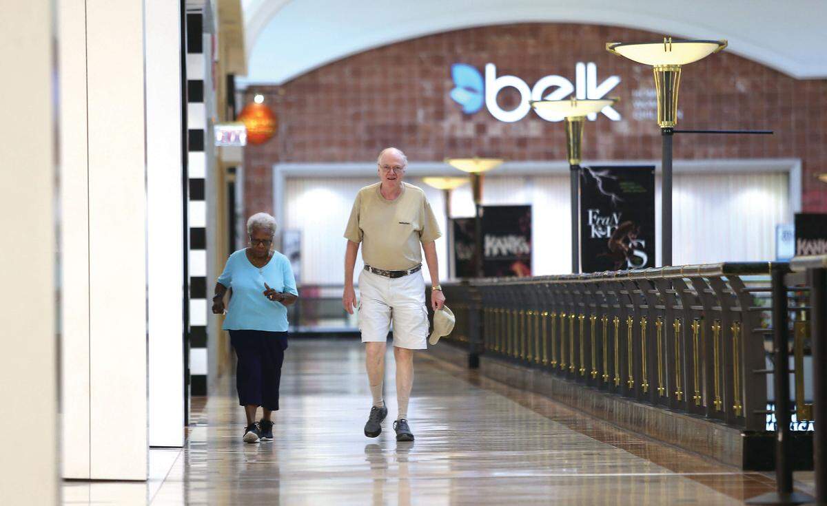 Mall walkers Joan Williams-France and Harvey Davis stroll through Crabtree Valley Mall in Raleigh. In Crabtree, twice around, plus the wings, is 1 mile.