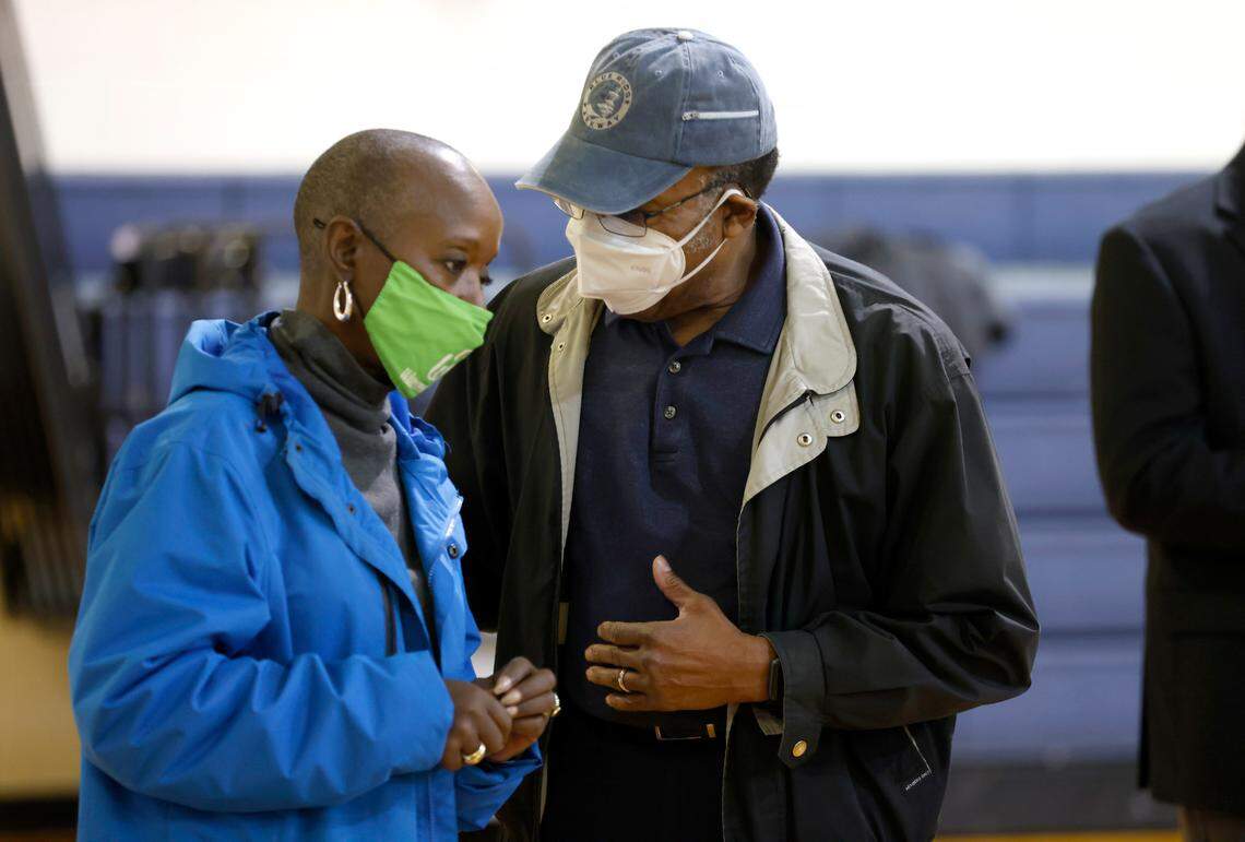Joe Jackson, right, talks with Winston-Salem city council member D.D. Adams after a press conference in Winston-Salem, N.C., Thursday, Feb. 3, 2022. Jackson temporarily moved in with his mother to help take care of her while her community is part of the evacuation zone of Winston Weaver Company fertilizer plant fire.