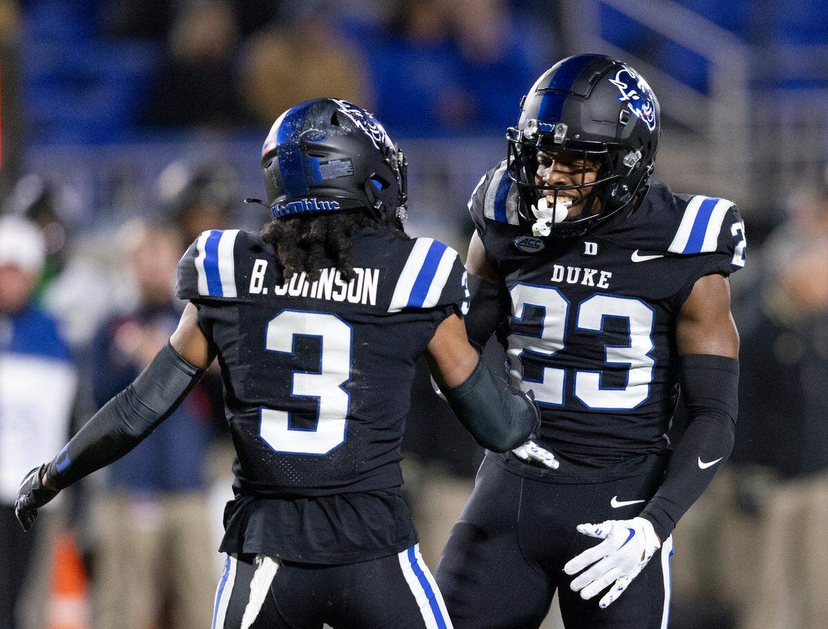Duke’s Terry Moore (23) is congratulated by teammate Brandon Johnson after he sacked Wake Forest quarterback Mitch Griffis during the first half of the Blue Devils’ 24-21 win on Thursday, Nov. 2, 2023, at Wallace Wade Stadium in Durham, N.C.