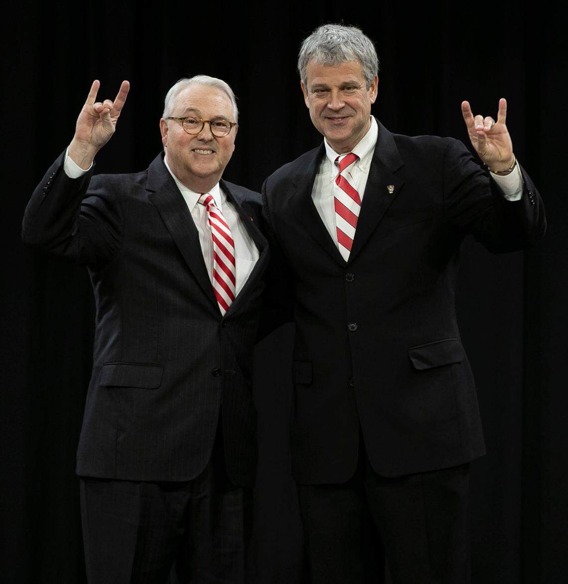 NC State chancellor Randy Woodson and Boo Corrigan display the Wolfpack hand sign after Corrigan was introduced as the new athletic director on Thursday, January 31, 2019 at Reynolds Coliseum in Raleigh, N.C.
