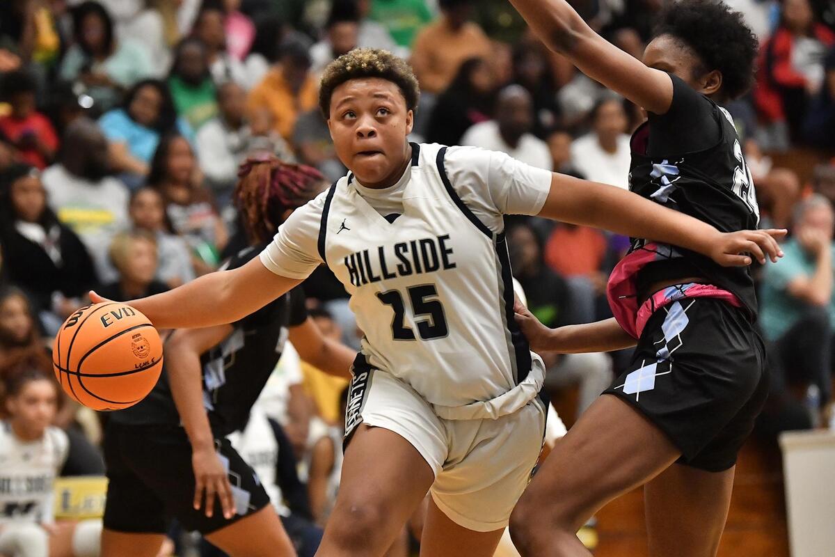 Hillside’s Breonna Malone (25) drives to the basket against Panther Creek’s Kirstin Smalls (24) during the second half. The Hillside Hornets and the Panther Creek Catamounts met in the NCHSAA 4A East Regional Finals in Sanford, N.C. on March 4, 2023.