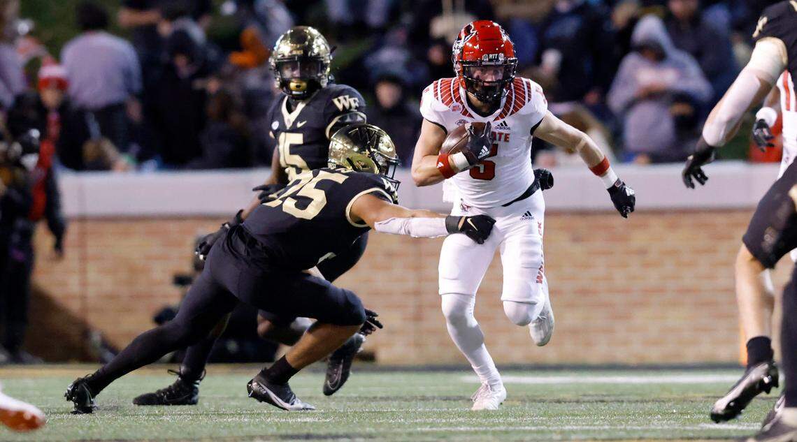 N.C. State’s Thayer Thomas (5) runs by Wake Forest defensive back J.J. Roberts (25) on a punt return during the Wolfpack’s game against Wake Forest at Truist Field in Winston-Salem, N.C., Saturday, November 13, 2021.