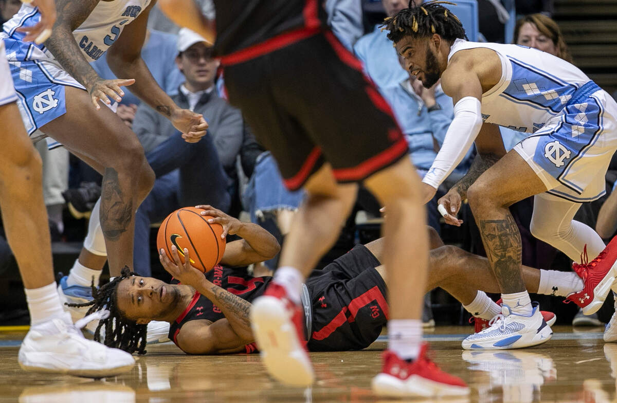 Gardner-Webb’s D.Q. Nicholas (4) hits the court in a trap by North Carolina’s Armando Bacot (5) and R.J. Davis (4) during the second half on Tuesday, November 15, 2022 at the Smith Center in Chapel Hill, N.C.