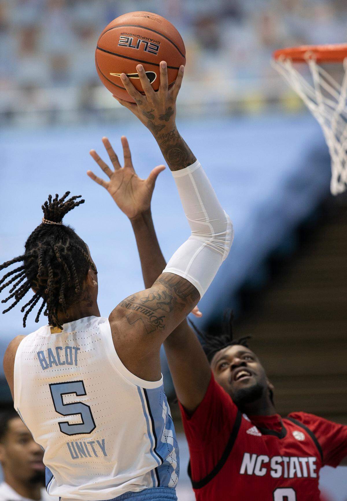 North Carolina’s Armando Bacot (5) shoots over N.C. State’s D J Funderburk (0) during the first half on Saturday, January 23, 2021 at the Smith Center in Chapel Hill, NC.