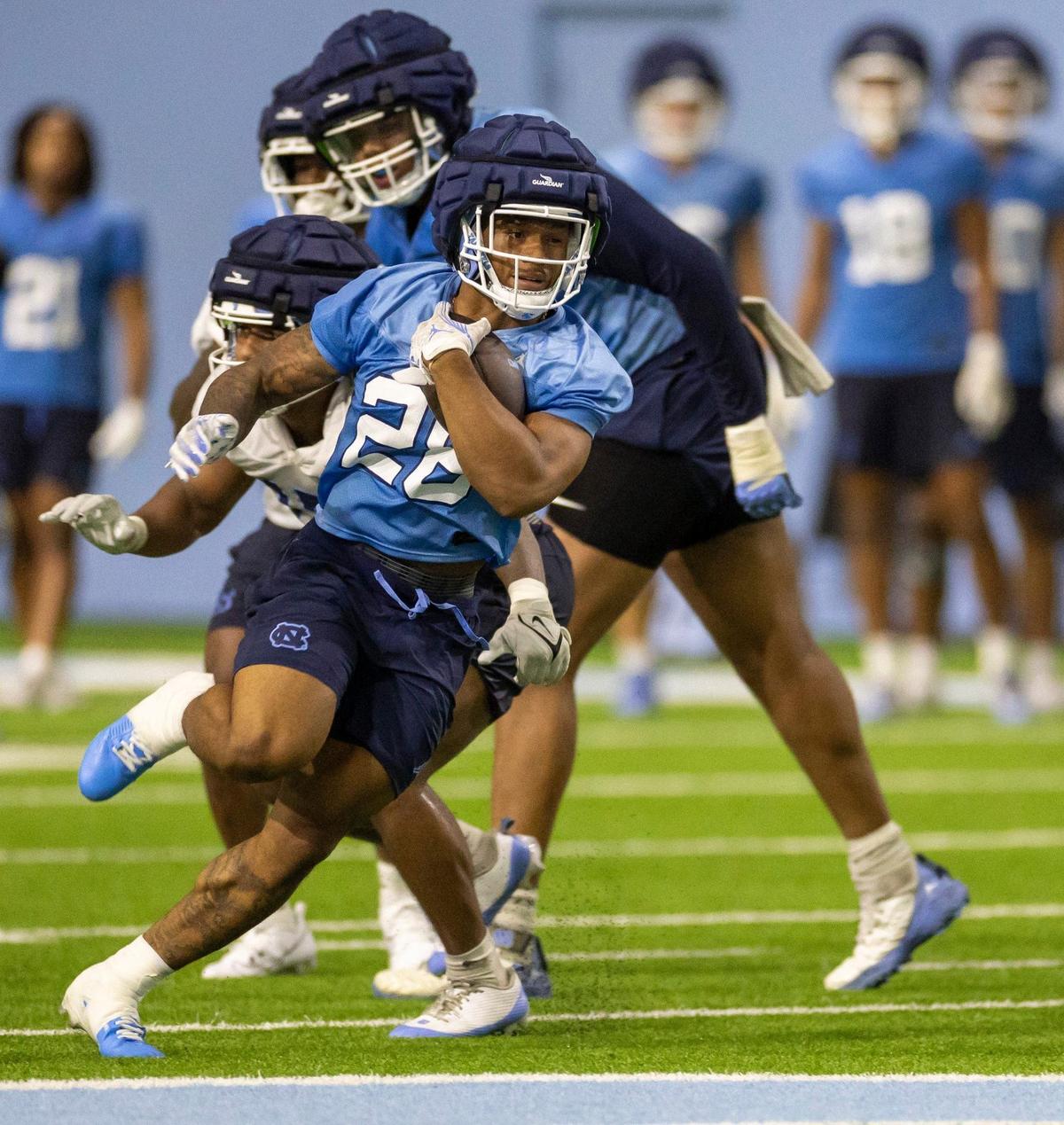 North Carolina running back Omarion Hampton (28) carries the ball during the Tar Heels’ first practice of the season on Monday, July 29, 2024 in Chapel Hill, N.C.