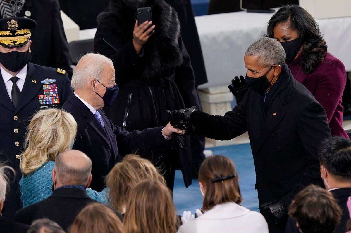 President-elect Joe Biden his greeted by former President Barrack Obama as he arrives for the 59th Presidential Inauguration at the U.S. Capitol in Washington, Wednesday, Jan. 20, 2021.