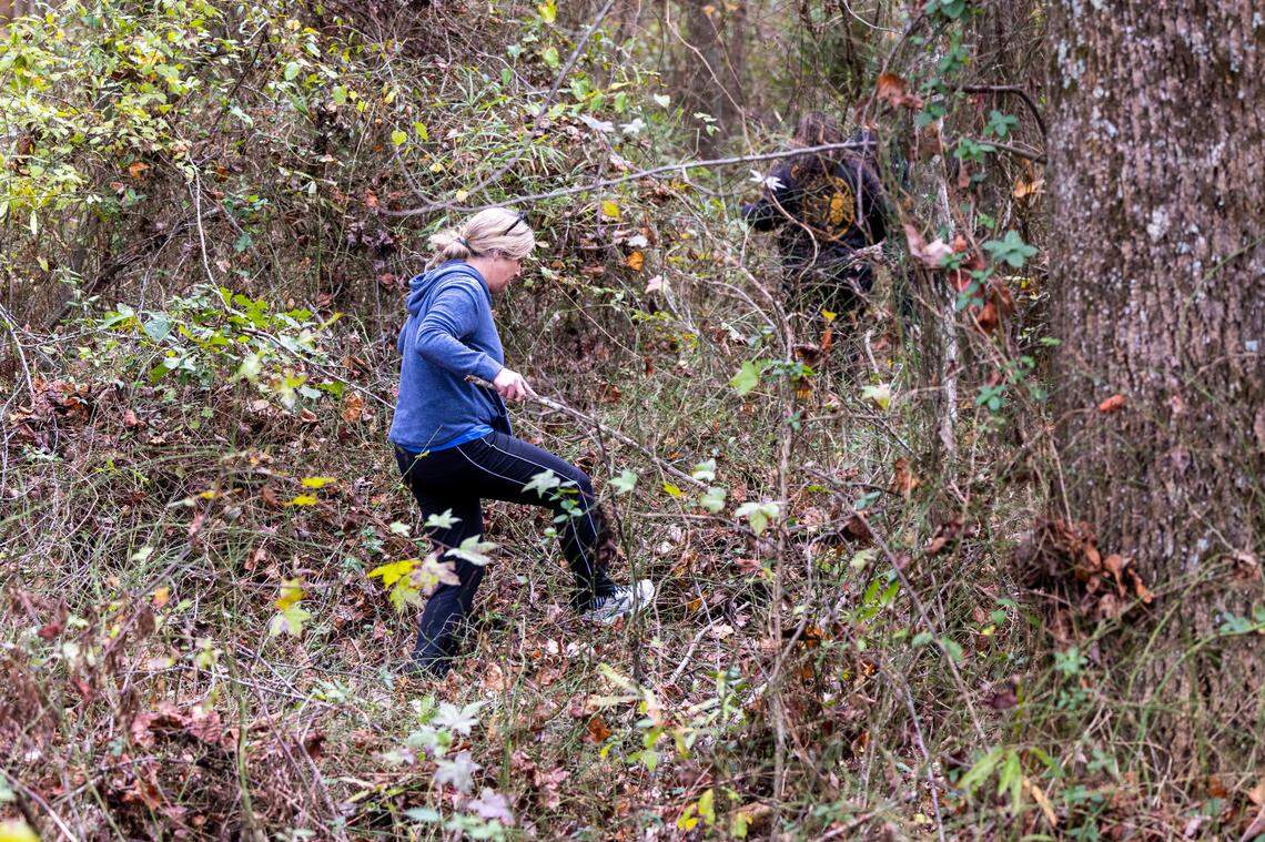 A volunteer searches a wooded area in Wendell Tuesday, Nov. 15, 2022 after 9-year-old Bentley Stancil went missing for more than 24 hours. Stancil was found safe, hiding in a camper.