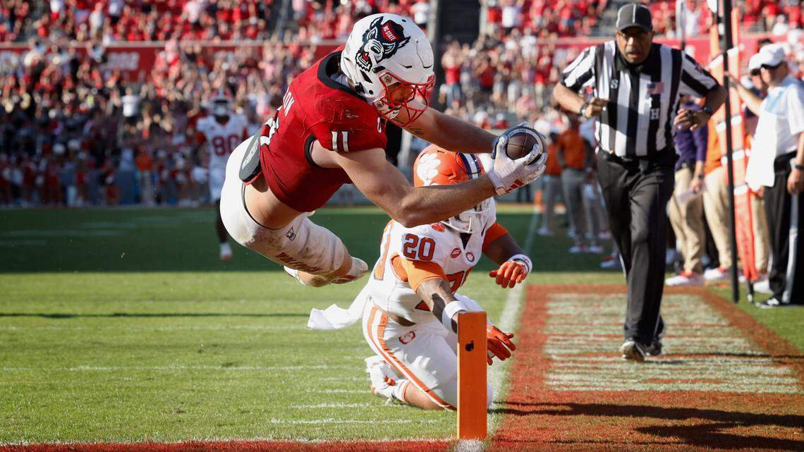 N.C. State linebacker Payton Wilson (11) dives in to score on a 15-yard touchdown interception during the second half of N.C. State’s 24-17 victory over Clemson at Carter-Finley Stadium in Raleigh, N.C., Saturday, Oct. 28, 2023.
