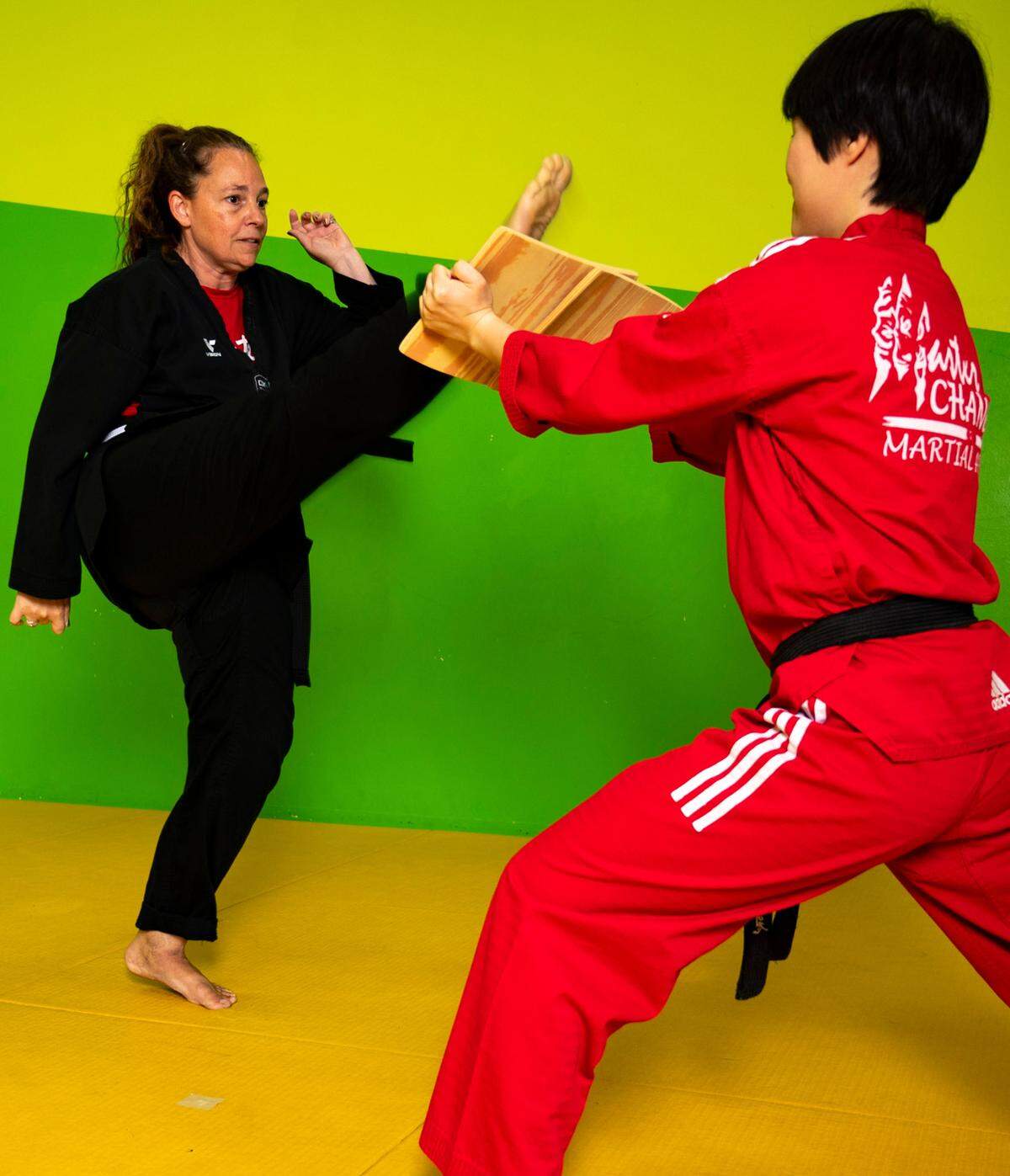 Laura Campbell practices with taekwondo instructor Gawan Lee at Master Chang’s Martial Art Studio in Durham, N.C. on June 4, 2024. After multiple serious injuries from a car accident, joining her sons at taekwondo felt out of the question. But after years of hard work Campbell has earned her black belt.