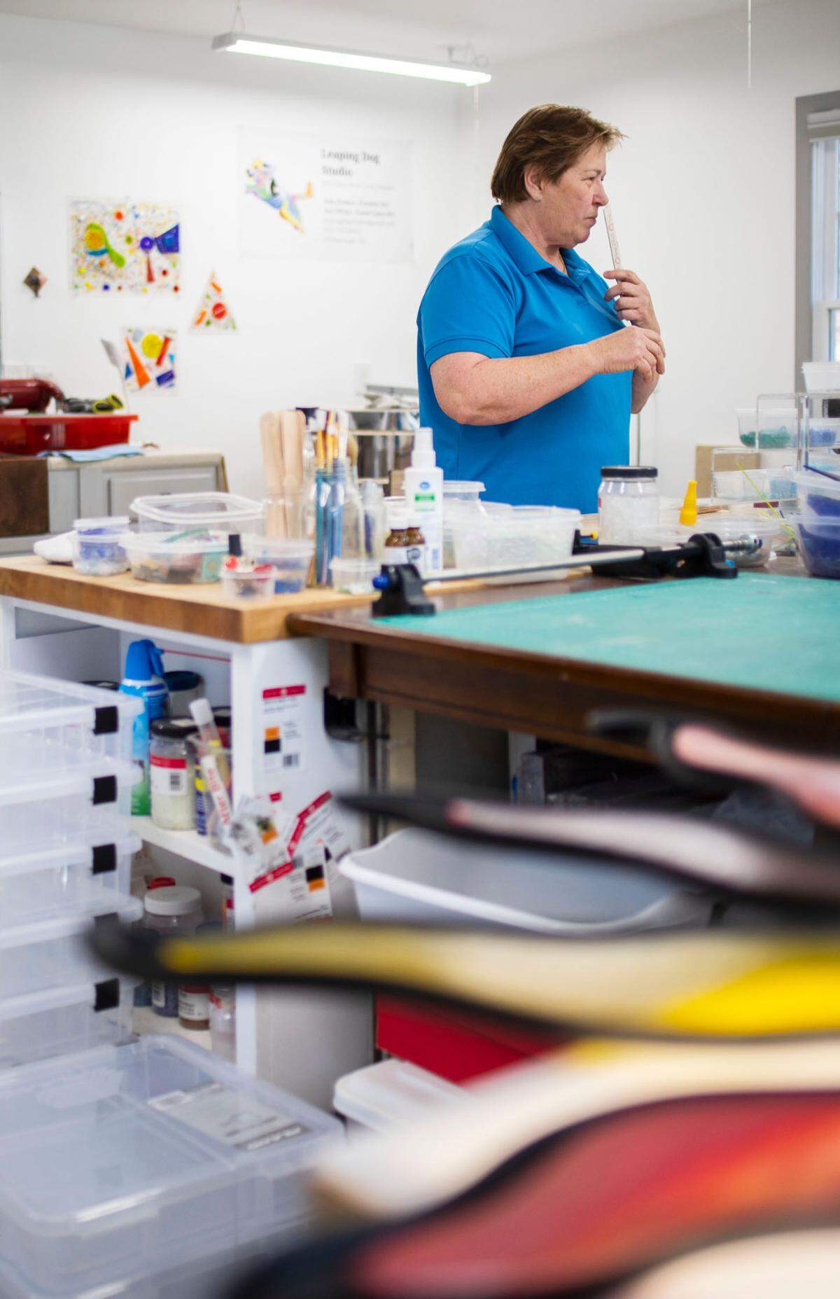 Joni White smells incense while in her glass art workshop at her home in Hillsborough, N.C., pictured here on Feb. 14, 2022.