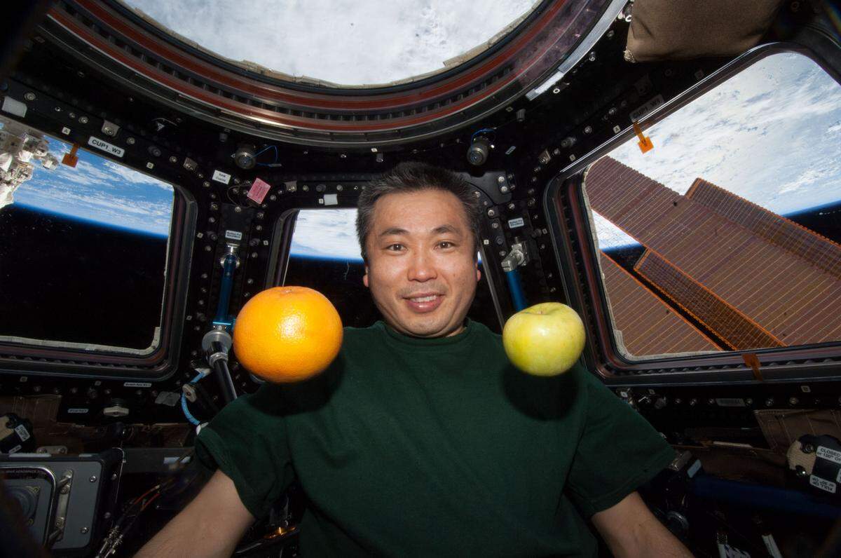 Koichi Wakata take a photo with fresh fruit that was brought to the International Space Station in this 2014 photo. Wataka, who is currently onboard the ISS, spoke with students at Brentwood Elementary School in Raleigh, N.C., via ham radio on Jan. 26, 2023.
