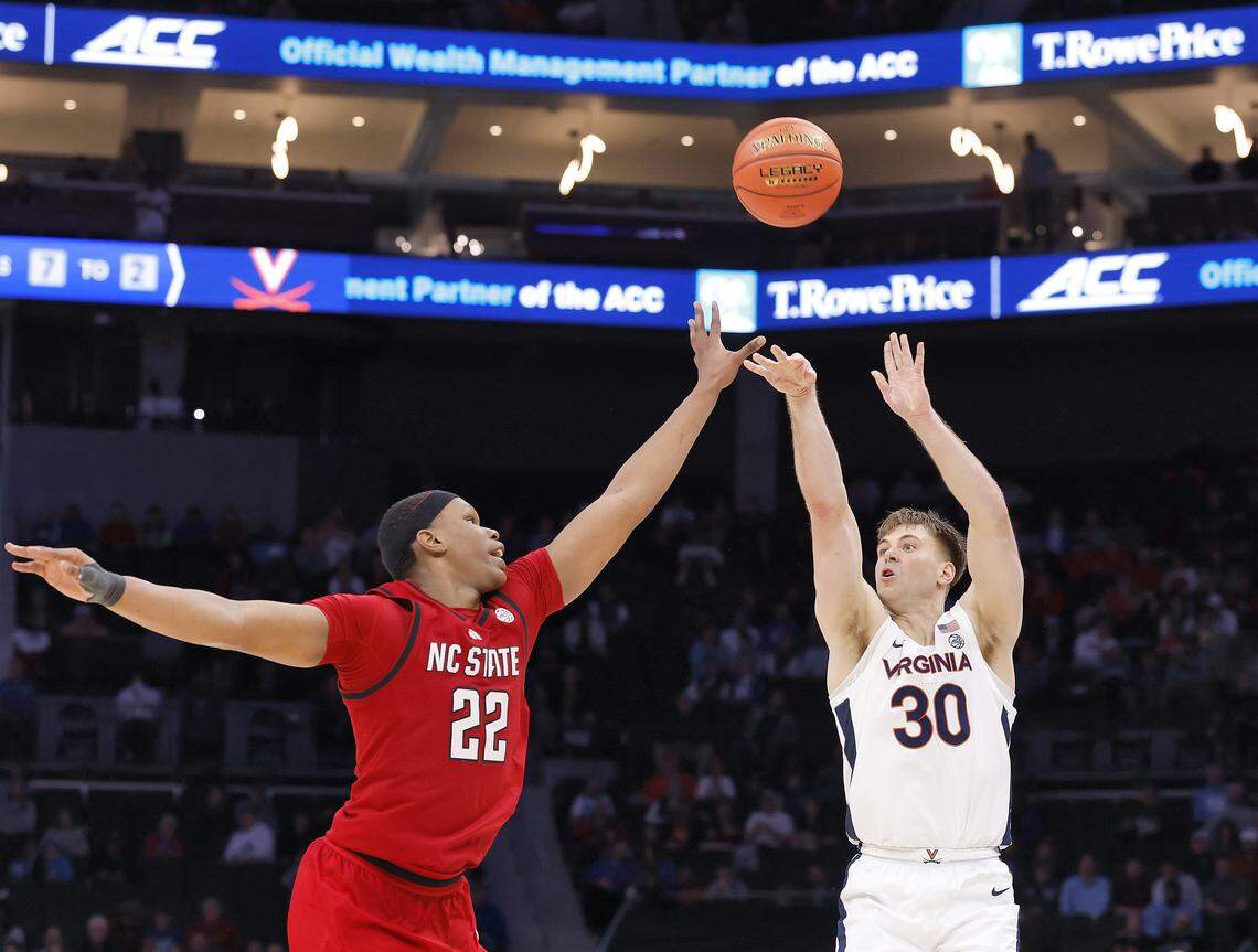 Virginia's Dallin Hall shoots over N.C. State's Ven-Allen Lubin during the second half of the Wolfpack’s 81-74 loss in the ACC Tournament quarterfinals on Thursday, March 12, 2026, at the Spectrum Center in Charlotte, N.C. 
