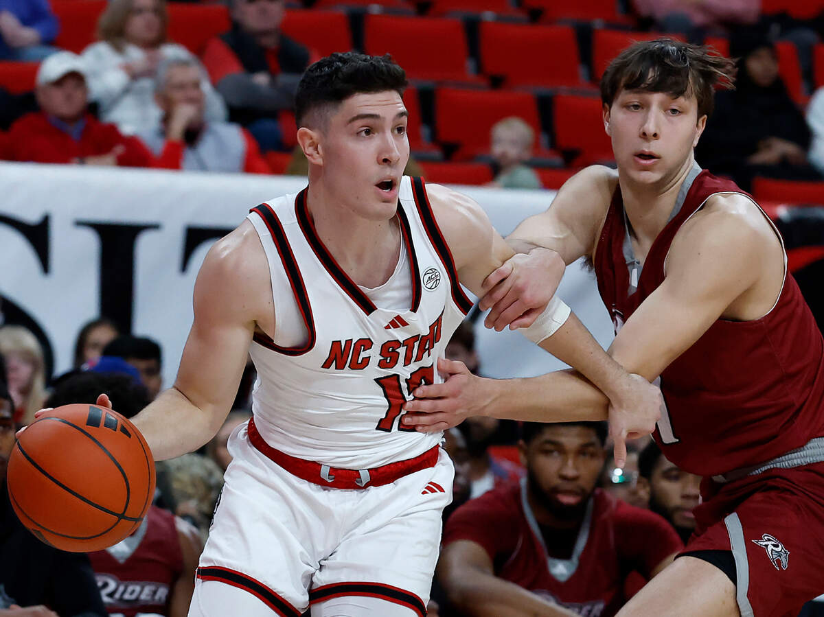 N.C. State’s Michael O’Connell dribbles past Rider’s Cole McCabe during the first half of the Wolfpack’s 89-63 win on Sunday, Dec. 22, 2024, at Lenovo Center in Raleigh, N.C.
