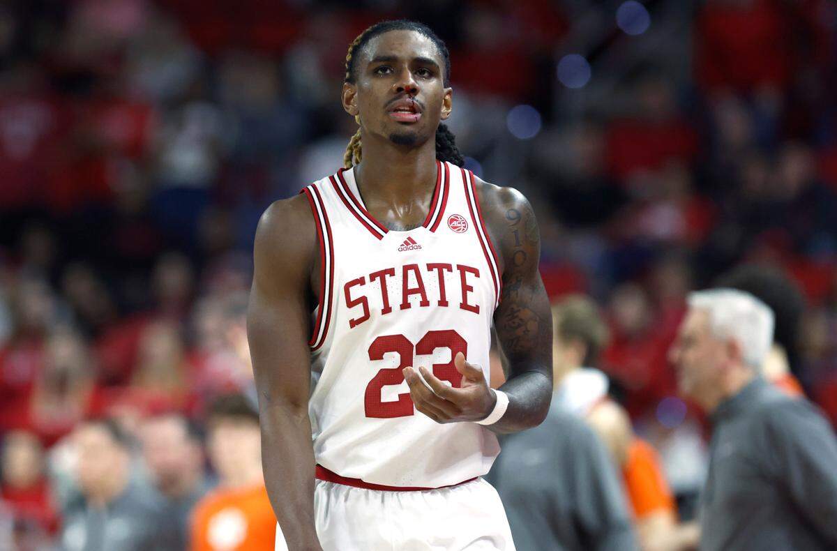 N.C. State’s Greg Gantt (23) walks back to the bench with a nose bleed during the second half of Clemson’s 96-71 victory over N.C. State’s game at PNC Arena in Raleigh, N.C., Saturday, Feb. 25, 2023.