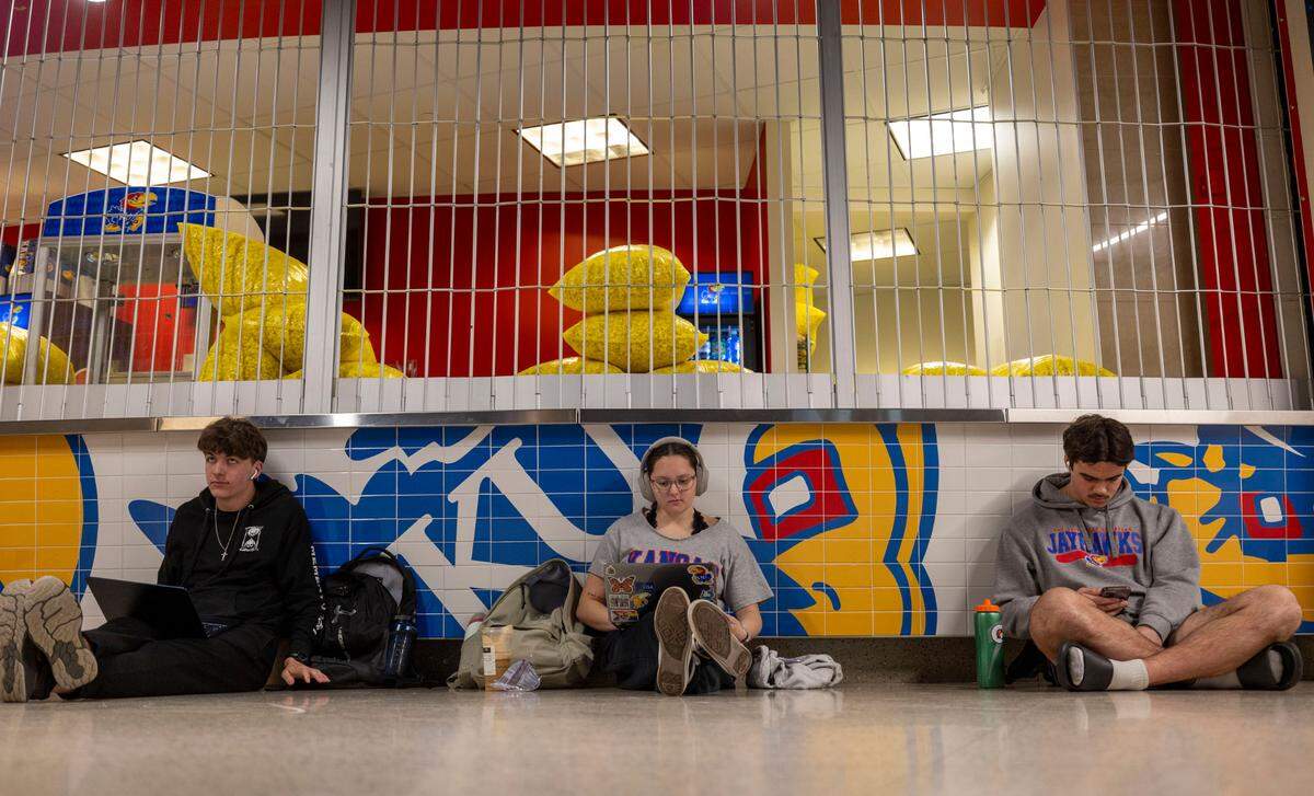 Kansas students wait in the lobby of Allen Fieldhouse for their tickets to the North Carolina vs Kansas game, as concession vendors prepare popcorn for the game on Thursday, November 7, 2024 in Lawrence, Kansas.