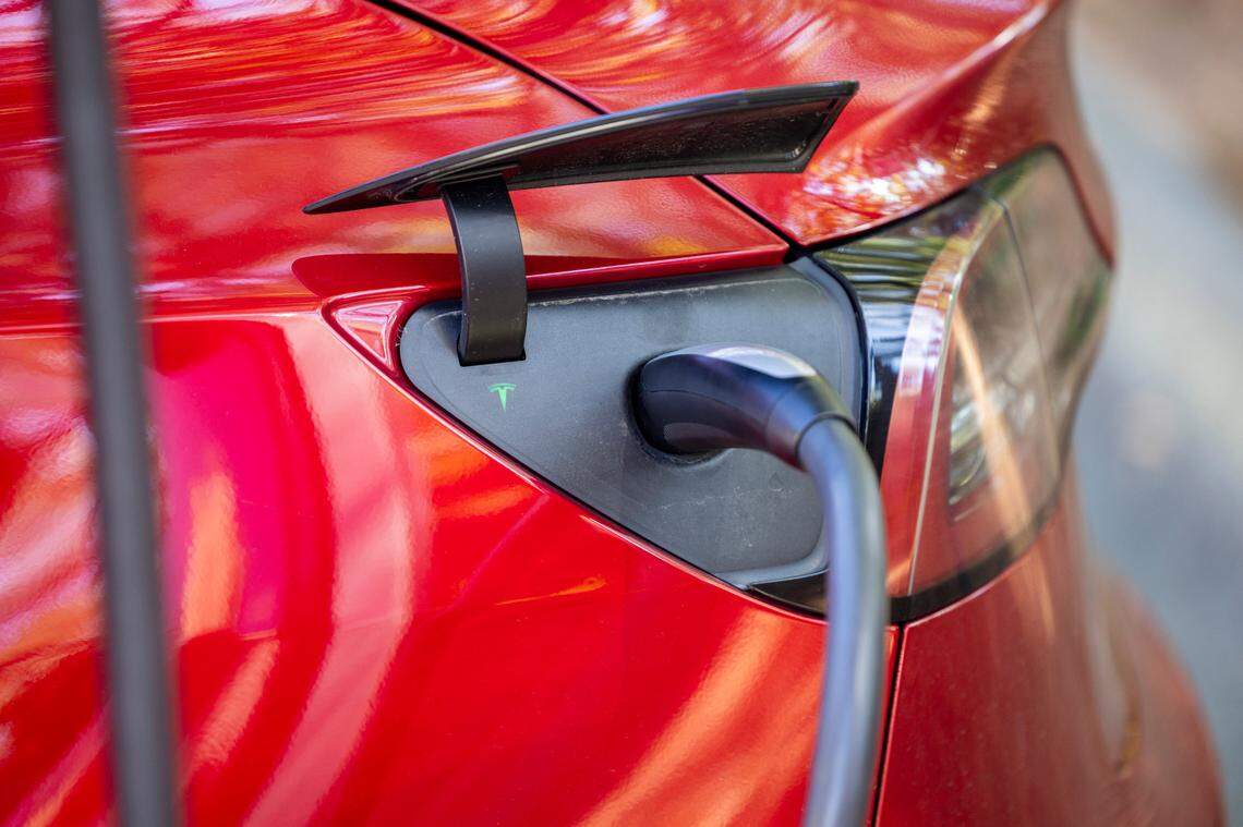 A Tesla charges at an electric charging station at North Hills in Raleigh Tuesday, October. 17, 2023. Electric vehicle owners will see an increase in annual registration fees.