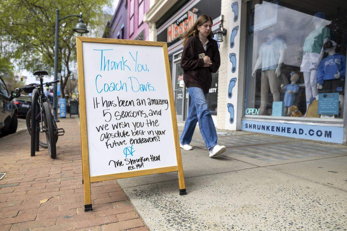 Longtime Franklin Street retailer The Shrunken Head, displays a sandwich board with sentiment for basketball coach Hubert Davis on Wednesday, March 25, 2026, in Chapel Hill, N.C. Davis, was let go by the University of North Carolina on Tuesday night, after leading the men’s basketball team for five years. 