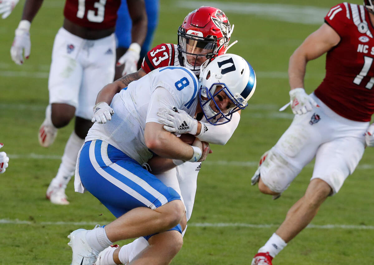 N.C. State cornerback Isaac Duffy (33) tackles Duke quarterback Chase Brice (8) during the second half of N.C. State’s 31-20 victory over Duke at Carter-Finley Stadium in Raleigh, N.C., Saturday, Oct. 17, 2020.