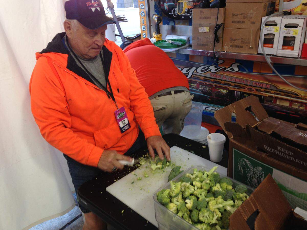 Ervin Herschel chops broccoli to get it ready to fry at Royer’s Fry Hop at the N.C. State Fair on its opening day, Friday, Oct. 12, 2018.