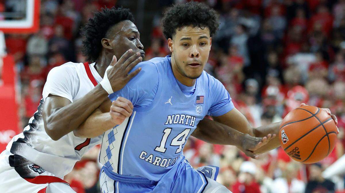 N.C. State’s Jarkel Joiner (1) defends against North Carolina’s Puff Johnson (14) during the first half of N.C. State’s game against UNC at PNC Arena in Raleigh, N.C., Sunday, Feb. 19, 2023.